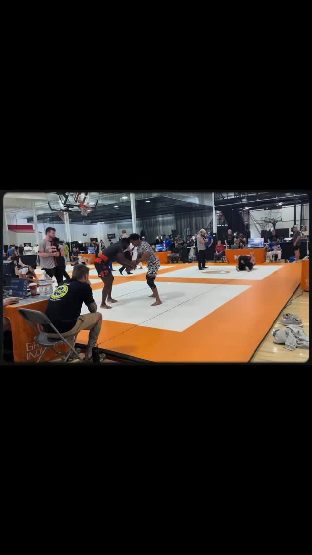 Two athletes grappling at a tournament in a post shared by kc_kingcrow740